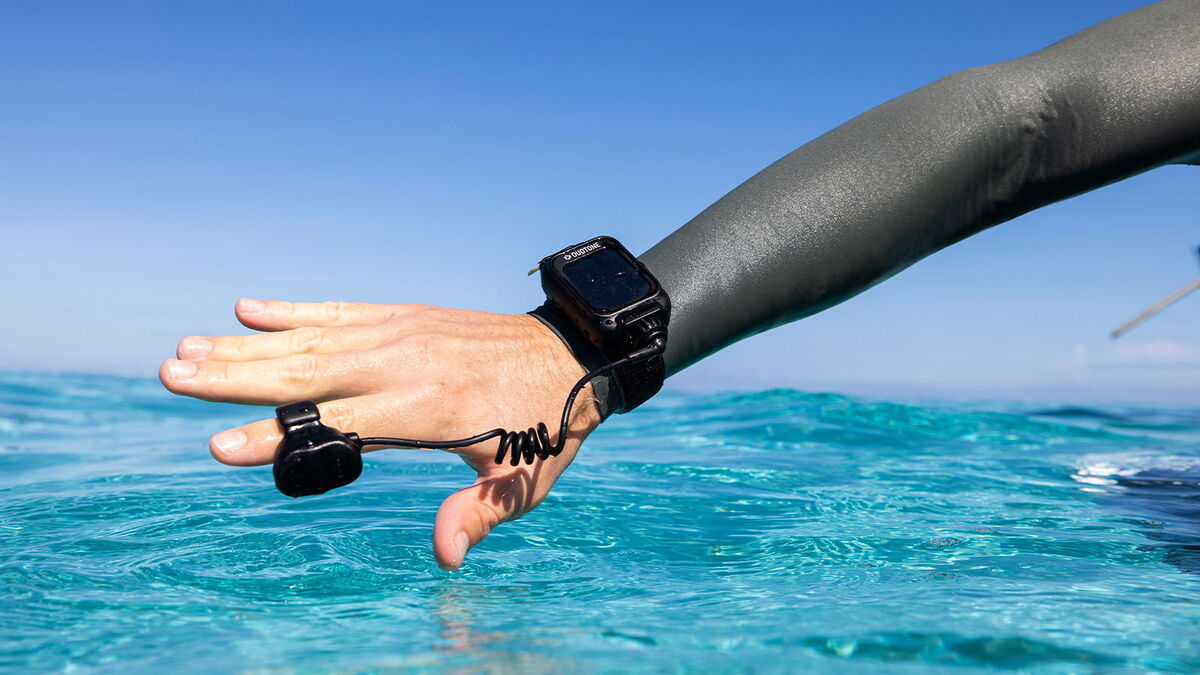 Close-up of Duotone Foil Assist watch ring remote on rider's wrist in Tahiti