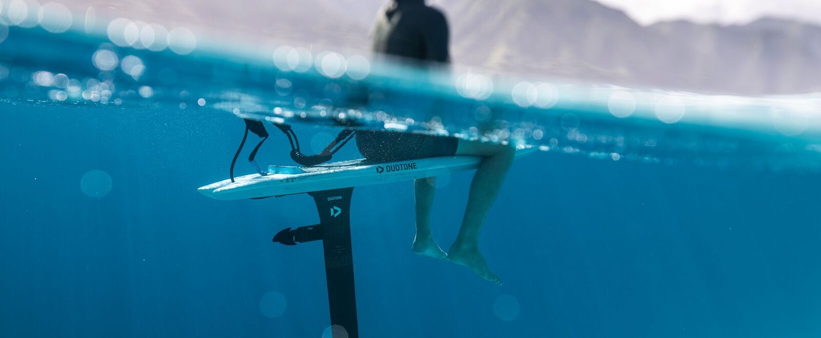 Underwater view of Duotone Midfish foilboard with Foil Assist mast and propeller in Tahiti